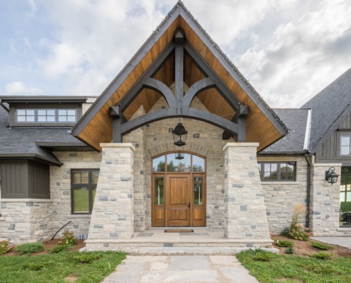 Stone front entry with wood soffit.