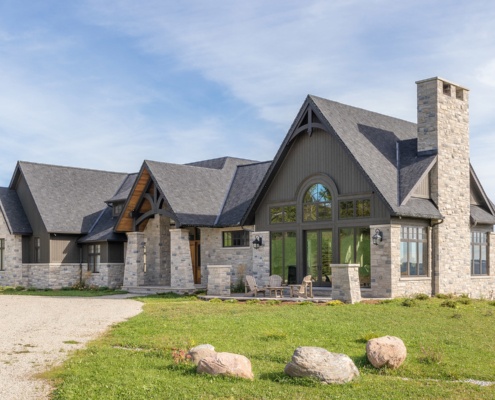 Collingwood house with stone siding and wood accents.