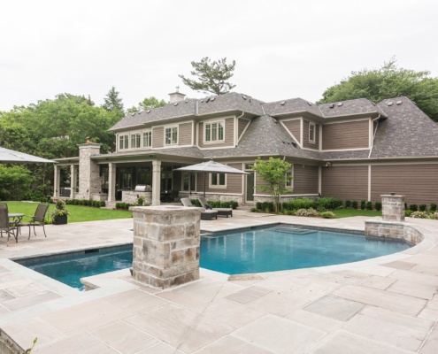 Mississauga house with Stone columns, stone chimney and outdoor living.
