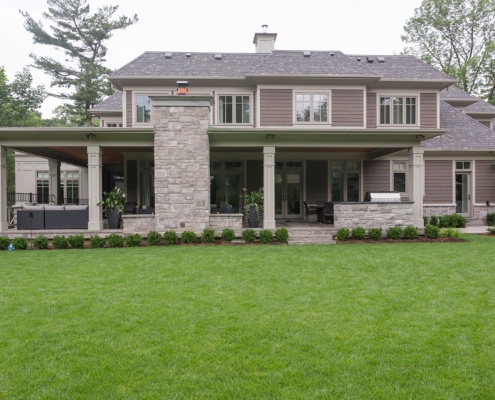 Oakville house with wood siding, stone and covered porch.