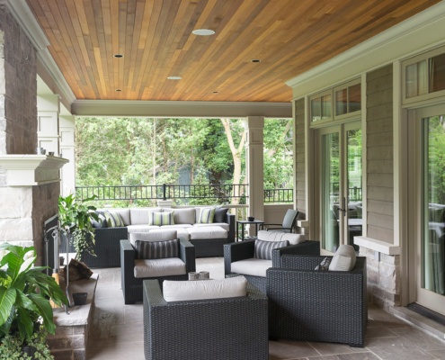 Backyard patio with stone fireplace, wood ceiling and flagstone floor.