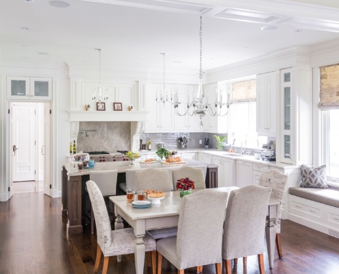 Dining room with white dining table, hardwood floor and window nook.