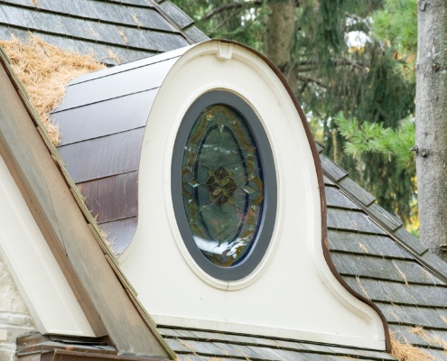 Mississauga home with oval window, copper detailing and natural stone siding.