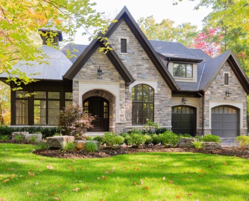 Home front entry with covered entry, large window and concrete wallway.