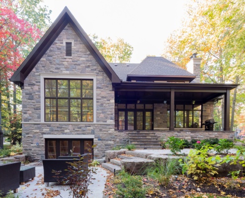 Mississauga house with covered porch, black frame window and large gable.