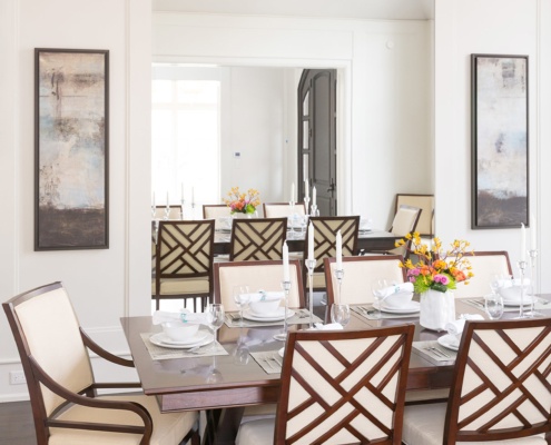 Dining room with hardwood floor, wood dining table and full length mirror.