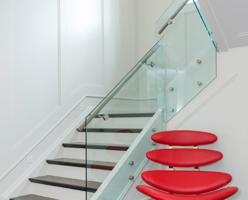 Modern house with wood stair, hard wood floor and glass railing.