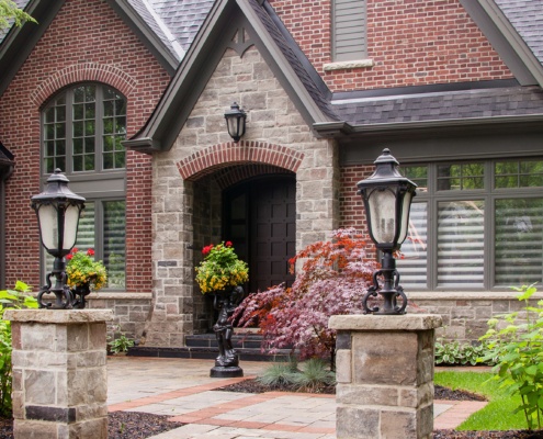 Mississauga house with covered entry, stone walkway and shingled roof.