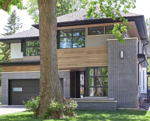 Modern house with large eaves, wood soffit and wood siding.