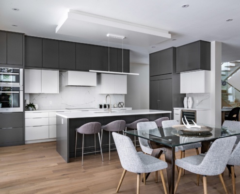 Contemporary kitchen with hard wood floor, glass dining table and floating stair.