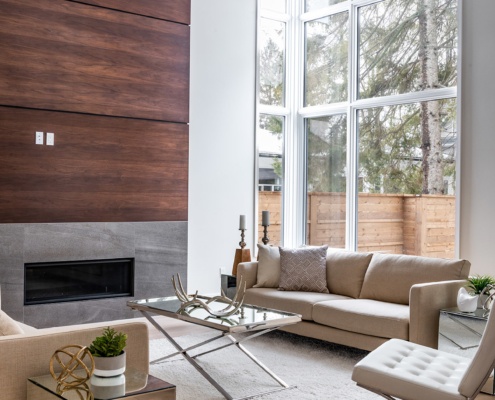 Mississauga family room with stone fireplace, pot lights and beige couch.