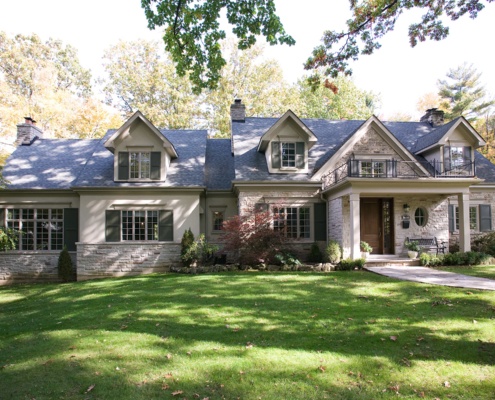 Mississauga custom home with stone skirt, stucco siding and shutters.