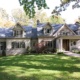 Mississauga custom home with stone skirt, stucco siding and shutters.