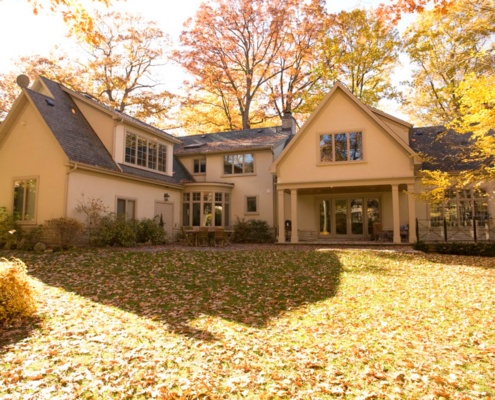 Traditional home with shingled roof, stucco siding and beige trim.