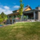 Transitional cottage with steel beams, stone columns and wood soffit.