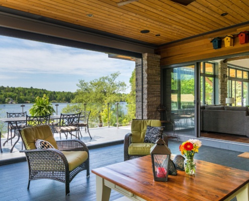 Covered patio with hardwood floor, natural stone and wood ceiling.