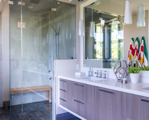 Master bathroom with floating vanity, glass shower and full length mirror.