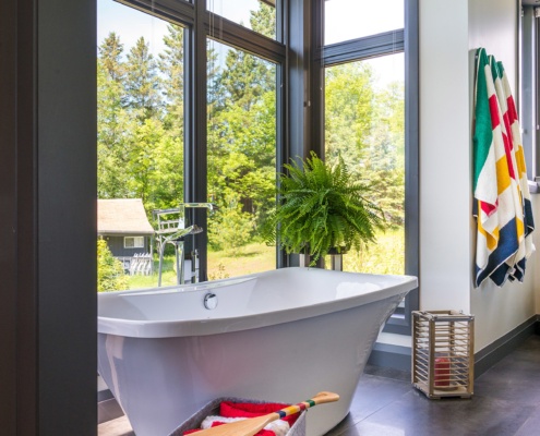 Modern bathroom with floor to ceiling window,