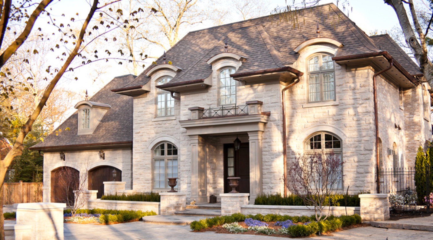 Mississauga home with arched windows, stone walkway and copper detailing.