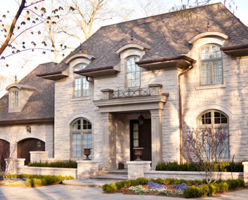 Mississauga home with arched windows, stone walkway and copper detailing.