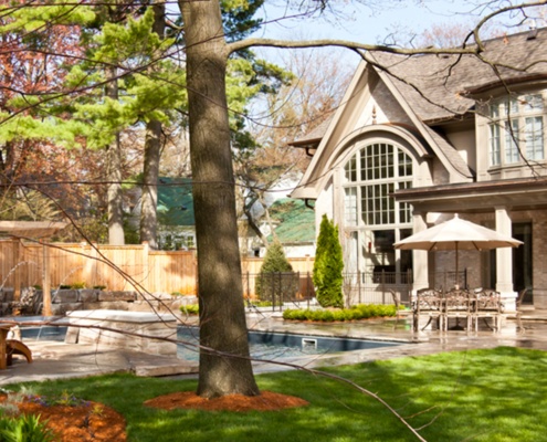 Mississauga house with stucco siding, natural stone and stucco columns.