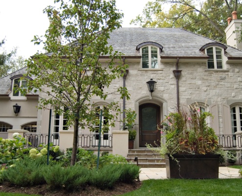 Traditional home with natural stone, stucco siding and stone walkway.