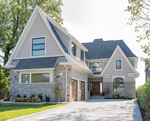 Traditional house with black frame window, white trim and gabled roof.