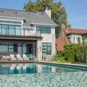 Mississauga custom home with natural stone, backyard pool and shingled roof.