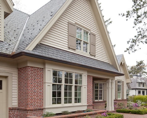 Mississauga home with red brick, stucco siding and shutters.