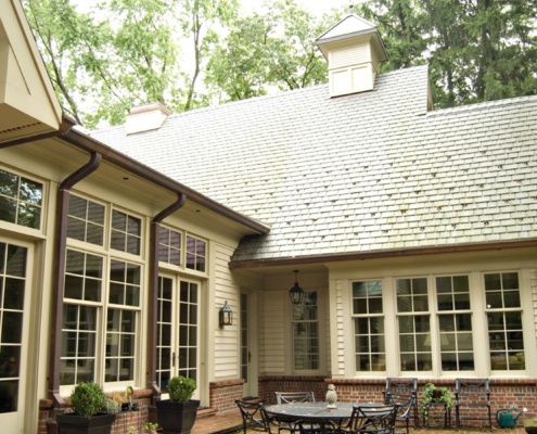 Traditional home design with horizontal siding, brick and grid windows.