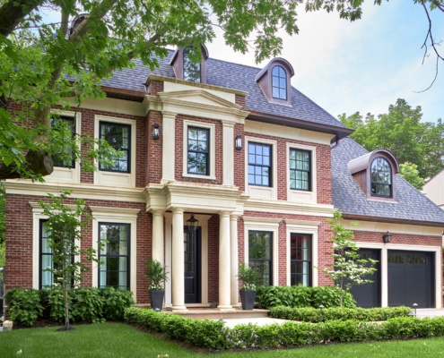 Toronto home with black garage door, large windows and copper details.