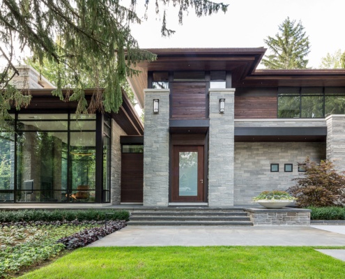 Mississauga house with wood trim, metal cladding and concrete planter.
