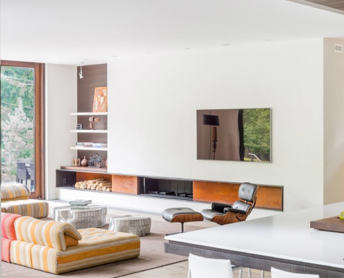 Modern living room with built in fireplace, white trim and built in shelves.