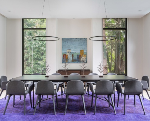 Modern dining room with floor to ceiling window, contemporary chandelier, and hardwood floors.