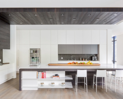 Mississauga kitchen with marble backsplash, double oven and wood ceiling.