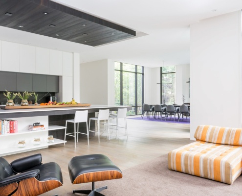 Open concept kitchen with large island, hardwood floor and white trim.