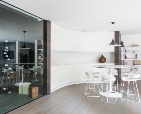 Wine cellar with curved wall and wood floor.