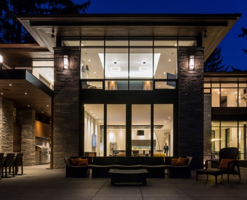 Flagstone patio with outdoor kitchen, dining table and wood ceiling.