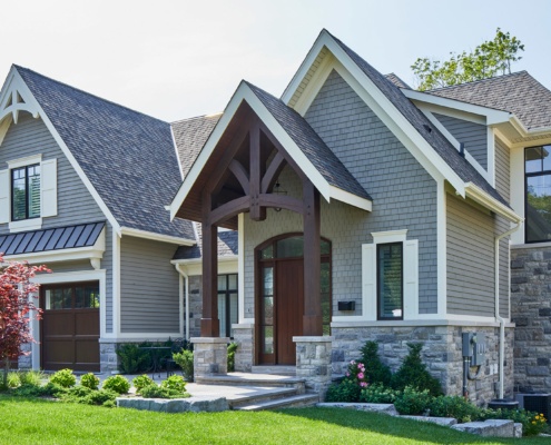 Mississauga custom home with corner windows, black frame windows and covered entry.