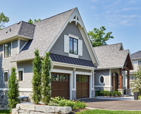 Mississauga house with wood garage door, white shutters and white trim.