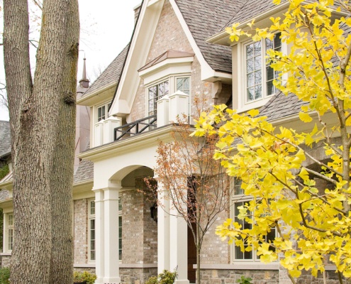 Mississauga custom home with covered entry, white columns and brick.