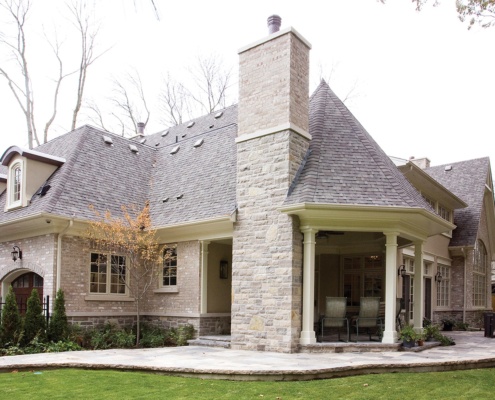 Traditional home with natural stone, white columns and brick.
