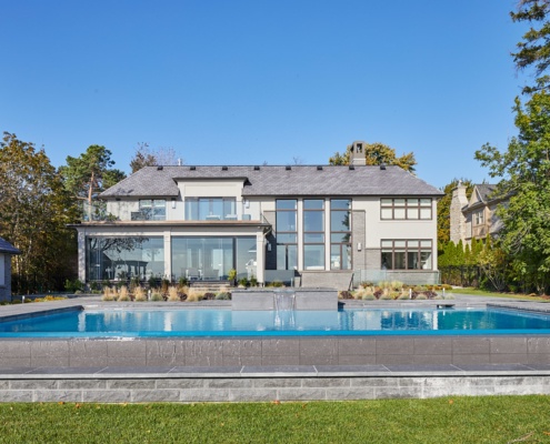 Mississauga home with infinity pool, glass railing and natural stone.