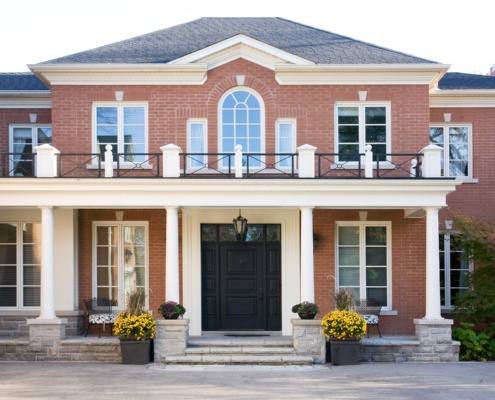 Mississauga renovation with arched window, black front door and shingled roof.