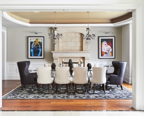 Traditional dining room with hardwood floor, white trim and glass table.