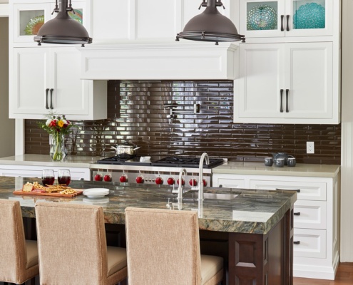 Custom kitchen with granite countertops, recessed cabinets and tiled backsplash.