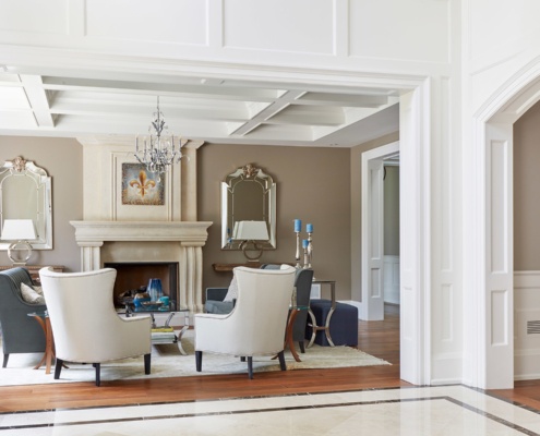Modern family room with floor, traditional chandelier, and white trim.