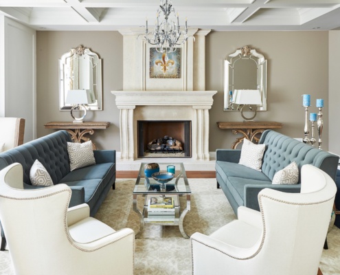 Traditional living room with white fireplace, white trim and hardwood floor.