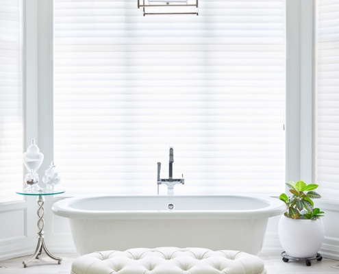 Master bathroom with tile floor, white trim and freestanding tub.