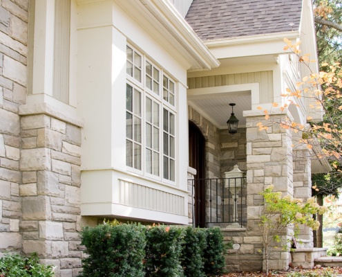 Mississauga home with stone siding, stucco siding and shutters.